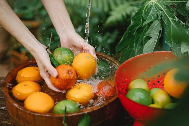 Photo by Any Lane: https://www.pexels.com/photo/woman-washing-fresh-fruits-in-tropical-orchard-5945641/